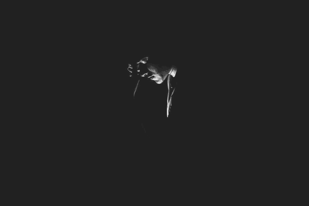 A lonely guy in the darkness in a state of anxiety and suicidal depression