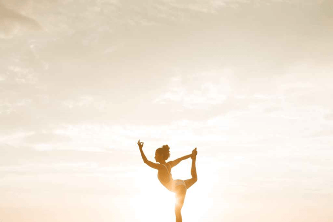 A free woman dancing freely in sunrise living who she really is doing what she wants