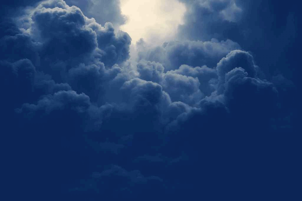 Spiritual inspiring sun beams flashing through the heavily clouded skies with hope