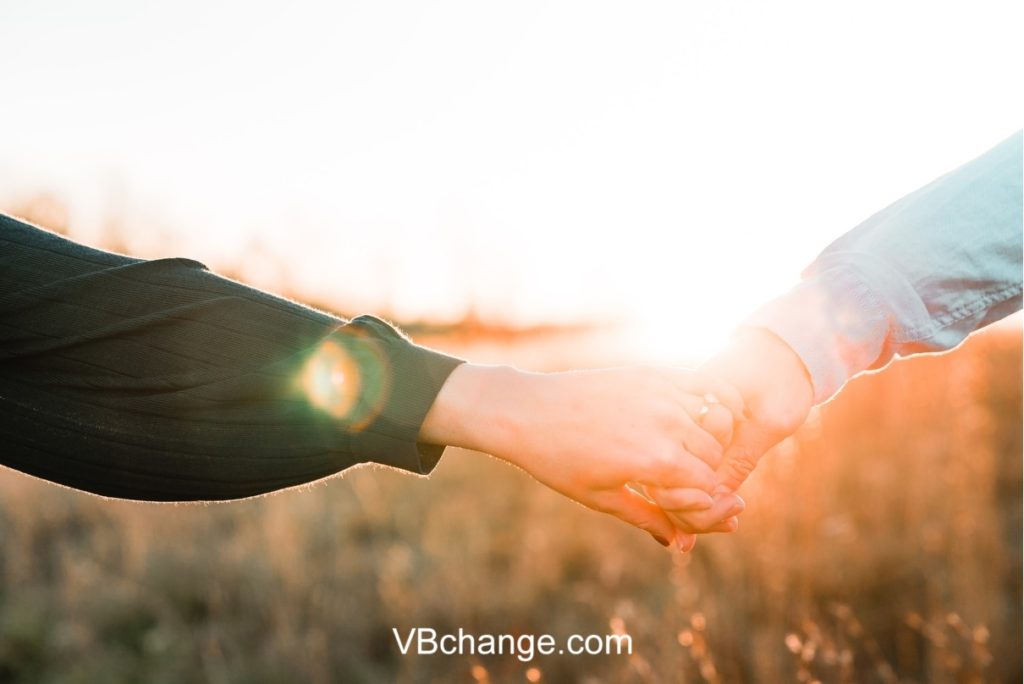 Romantic couple holding hands in the eve of the day